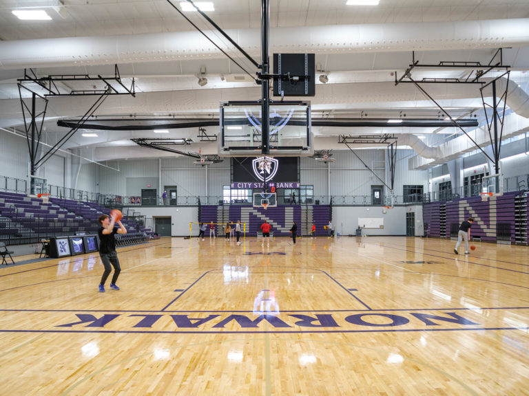 Gym interior with PE students playing games